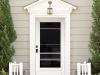 Dark green seasonal Front Door with red wreath.